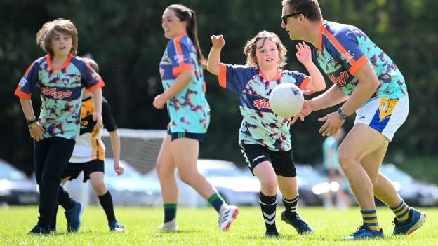 Dublin footballer Ciarán Kilkenny is tackled by Réalta Moran at the Kellogg’s GAA Cúl Camp in St Brendan’s GAA Club, Dublin. The camp was attended by Siún Brophy, the 1 millionth child to register for the the Kellogg's GAA Cúl Camps since the beginning of the Kellogg sponsorship in 2012. 