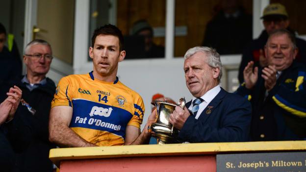 Clare captain Gary Brennan is presented with the McGrath cup by Munster Council Chairman Jerry O'Sullivan after the McGrath Cup Final match between Cork and Clare at Hennessy Park in Miltown Malbay, Co. Clare.
