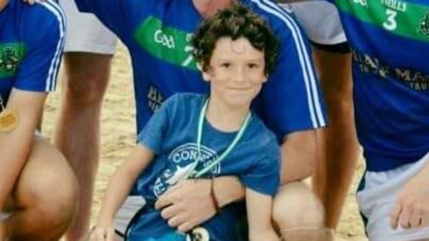 Justin Parks and his son Jake pictured before Costa Gaels play a game of beach gaelic football. 