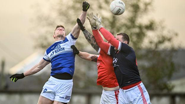 Tommy Walsh of Kerins O'Rahillys scores his side's first goal despite the efforts of Aaron Fitzgerald, left, and Shane Daniels of Éire Óg Ennis during the AIB Munster GAA Football Senior Club Championship Semi-Final match between Kerins O’Rahillys and Éire Óg Ennis at Austin Stack Park in Tralee, Kerry.