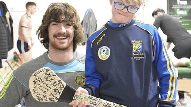 Ailis Malone pictured with Offaly senior hurler, Ben Conneely, and holding a hurley autographed by all the Offaly senior hurling panel. 
