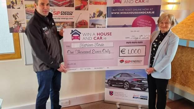 Athenry Camogie Club's Win a House and Car monthly draw winner for April, Kathleen Forde, pictured being presented with her cheque for €1,000.