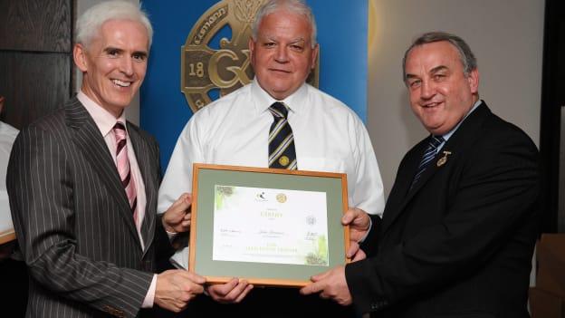 John Morrisson receiving his Tutor Trainer Certificate in 2008 from Michael McGeehan, left, Director Coaching Ireland and Nickey Brennan, former President of the GAA. 