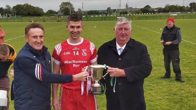 Knockbridge captain, Gareth Hall, is presented with the Cup after victory over st. Fechin's in the Louth SHC Final. 