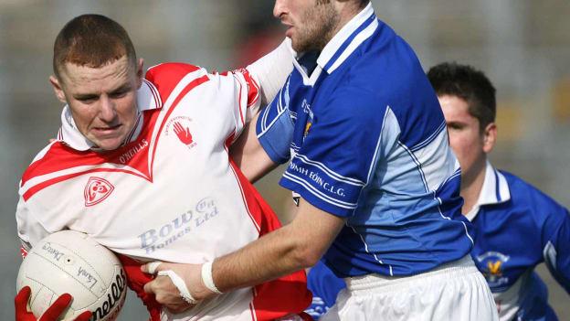 Patrick Cunningham, Lamh Dhearg, and Liam Knocker, St. John's, in action during the 2006 Antrim SFC Semi-Final replay.