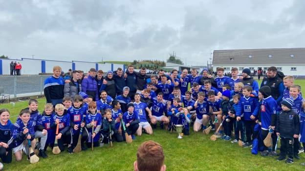 The Tooreen senior hurlers celebrate with some of the club's underage stars after winning the 2022 Mayo SHC Final. 