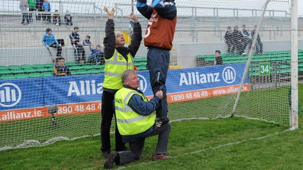 Dublin squad member John Hetherton fixes the goal net with a helping knee from Jim Kelly before 2011 Allianz Hurling League Division 1 match between Offaly and Dublin at O'Connor Park.  