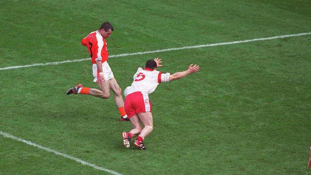 Tyrone's Conor Gormley blocks a late shot from Armagh's Steven McDonnell in the 2003 All-Ireland SFC Final. 