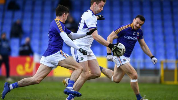 Paul Kingston, Laois on his way to shoot a goal despite the attentions of Longford defenders Iarla O'Sullivan, left, and Donal McElligott during the Leinster GAA Football Senior Championship Quarter-Final.