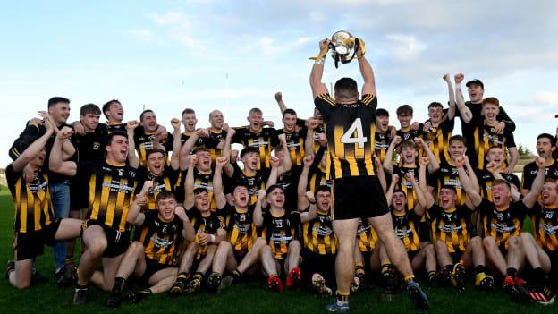 Strokestown joint captain David Neary, celebrates with the Fahey Cup and his teammates after their side's victory in the 2022 Roscommon SFC Final 