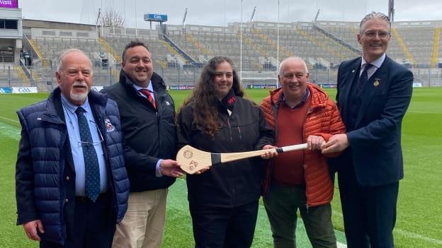 GAA President Jarlath Burns presenting a hurl with the GAA crest and McKay family crest to Philip Byrne, Simon McKay, Emilia McKay, and Patrick McKay at Croke Park.