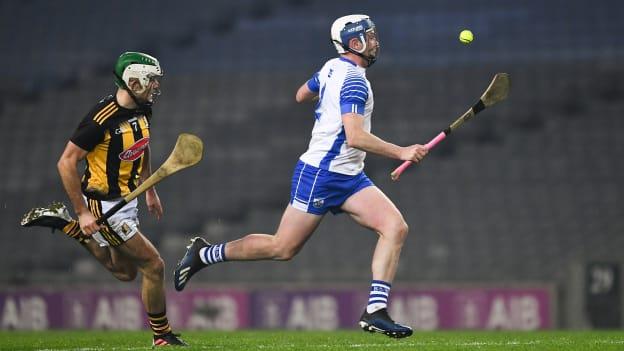 Stephen Bennett of Waterford races clear of Paddy Deegan of Kilkenny on his way to scoring a point during the GAA Hurling All-Ireland Senior Championship Semi-Final match between Kilkenny and Waterford at Croke Park in Dublin.
