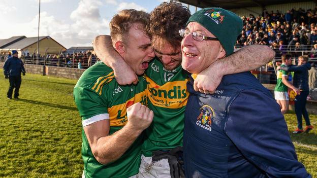 Clonmel Commercials players Kevin Fahey and Ross Peters celebrate with supporter Joe McNamara.