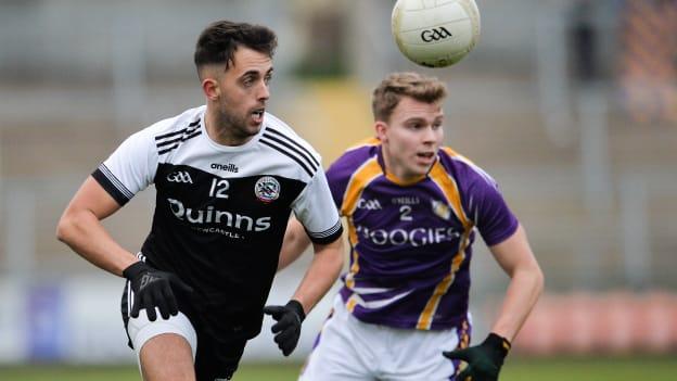 Ryan Johnston, Kilcoo, and Jack Love, Derrygonnelly Harps, during the AIB Ulster Club SFC Semi-Final at the Athletic Grounds.