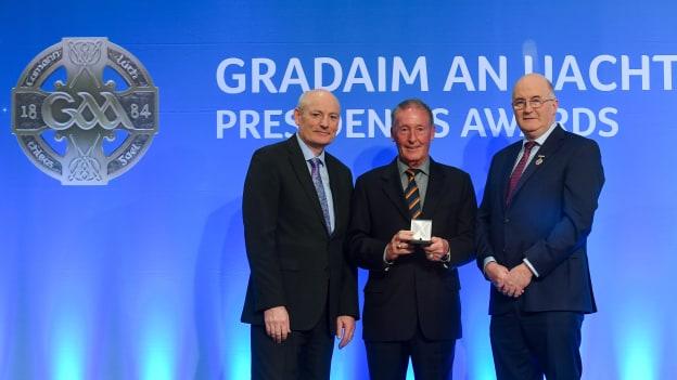 Hugh Duggan, Armagh & USGAA is presented with the International Award by Uachtarán Chumann Lúthchleas Gael John Horan, right, and Denis O'Callaghan, Head of Distribution at AIB, during the 2019 GAA President's Awards at Croke Park in Dublin. 