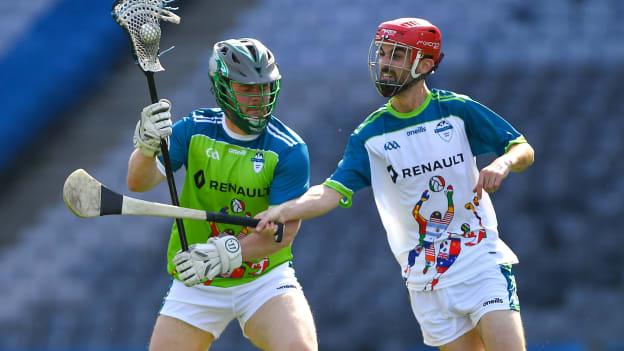 Cian Kelly of Ireland, left, in action against David Wogan of Europe during a Hurling/Lacrosse Exhibition Game at Croke Park for the Renault GAA World Games 2019.