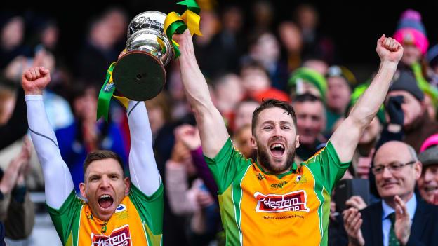Joint Corofin captains Ciaran McGrath and Micheal Lundy lift the Andy Merrigan Cup at Croke Park.