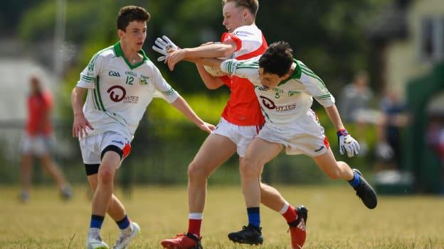 John Lavery of O'Donovan Rossa GAC in action against Rory McCormack, left, and Ian Kavanagh of New York during their John West Féile Peil na nÓg National Competitions 2018 match at Stamullen GAA in Meath. 