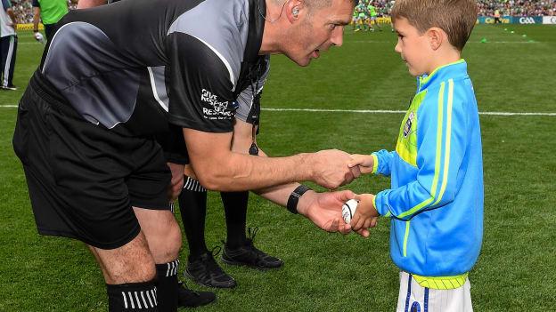 Six year old Rian O’Connor presents referee James Owens with the match sliothar before the GAA Hurling All-Ireland Senior Championship Final match between Galway and Limerick at Croke Park in Dublin. 