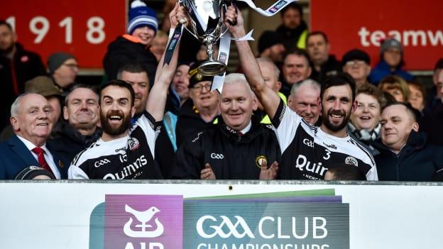 Laverty and Kilcoo joint-captain Aidan Branagan lift the Ulster Club SFC trophy back in December.