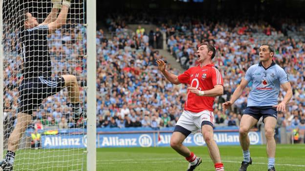 Dublin goalkeeper Stephen Cluxton keeps the ball from crossing the line despite the attention of Donncha O'Connor, Cork, and team-mate Paul Brogan. 