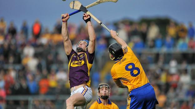 Jack Guiney, Wexford, and Patrick Donnellan, Clare, during the 2014 All Ireland SHC Round 1 replay at Wexford Park.