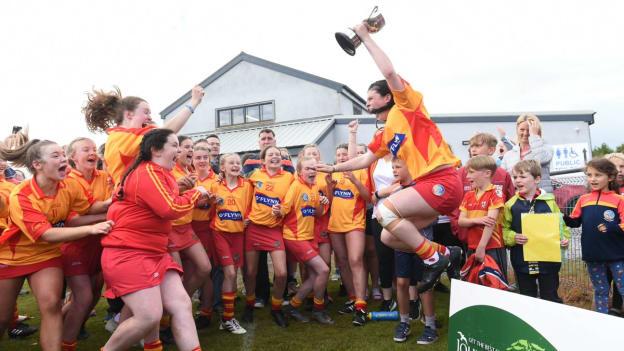 Éire Óg players celebrate after winning the John West Féile na nGael Division 1 Camogie title. 