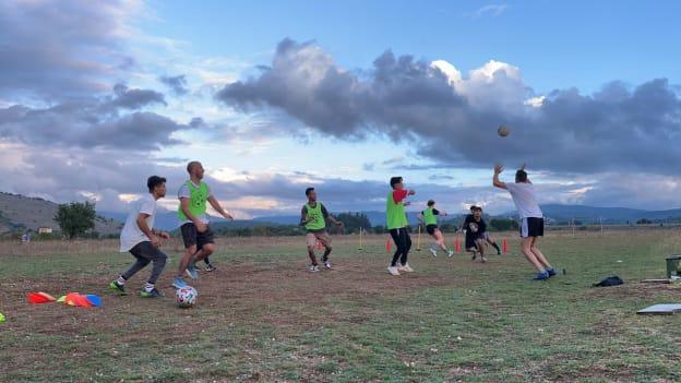 Gaelic Games Europe's Coaching and Games Development Officer, Alexandre San Martin Costa, pictured coaching a Gaelic football session in Katsikas refugee camp in Greece. 