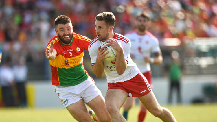Niall Sludden, Tyrone, and Shane Redmond, Carlow, collide at Netwatch Cullen Park.