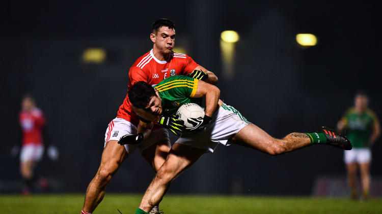 Ben Brennan, Meath, and Thomas Clancy, Cork, collide at Pairc Ui Rinn.