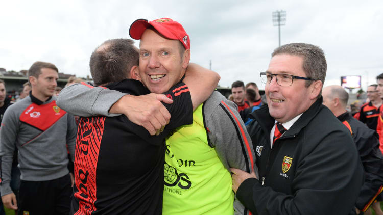 Eamonn Burns celebrates with fans and Down Chairman Sean Rooney, right, after managing Down to victory over Monaghan in the 2017 Ulster SFC semi-final.