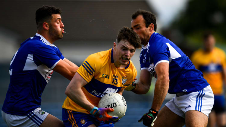 Clare's Gavin Cooney surrounded by Laois' Gareth Dillon and Robert Pigott at Cusack Park.