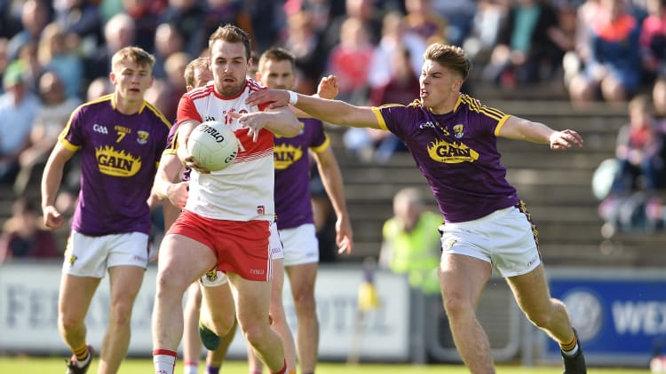 Ryan Bell of Derry in action against Eoin Porter of Wexford during the GAA Football All-Ireland Senior Championship Round 1 match between Wexford and Derry at Innovate Wexford Park in Wexford.