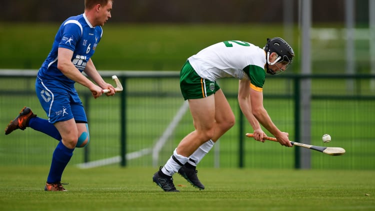 Donal Burke, Ireland, and Craig Ritchie, Scotland, in action during the Under 21 Hurling-Shinty International at the Games Development Centre in Abbotstown.
