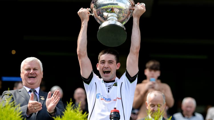 Warwickshire captain Donncha Kennedy lifts the Lory Meagher Cup.