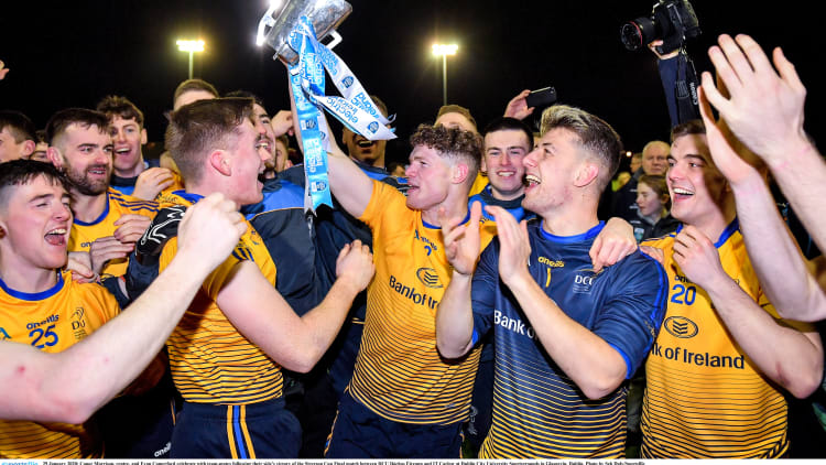 Conor Morrison, centre, and Evan Comerford celebrate with team-mates following DCU Dóchas Éireann's victory over Carlow IT in the Electric Ireland Sigerson Cup Final.