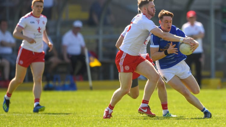 Ciaran Brady, Cavan, and Frank Burns, Tyrone, collide at Brewster Park.
