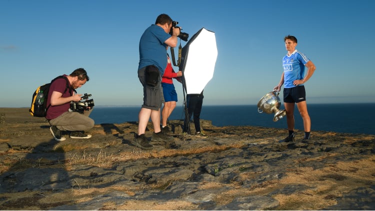 Photographers and videographers photograph Michael Fitzsimons of Dublin with the Sam Maguire Cup during the GAA Hurling and Football All Ireland Senior Championship Series National Launch at Dún Aonghus, Inis Mór.