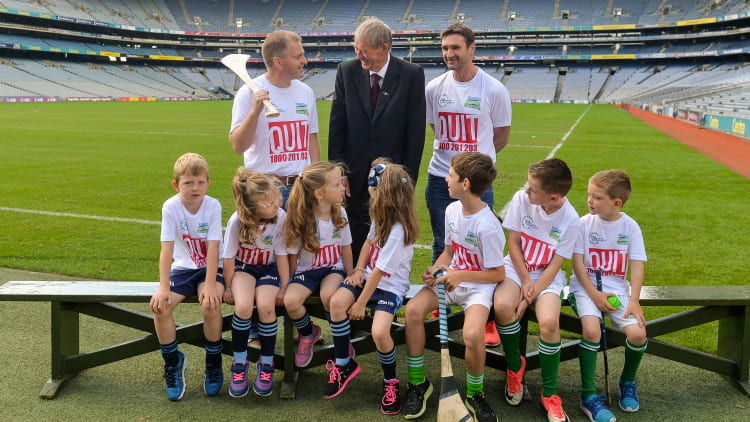 #hurlthehabit ambassadors, from left, former Cork hurler Joe Deane, former commentator Mícheál Ó Muircheartaigh, and former Waterford hurler Tony Browne, with children from the Killeagh GAA club, Co Cork, and St Colmcilles, GAA club, Co Meath at Croke Park.