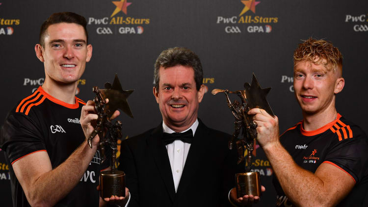 Feargal O'Rourke, Managing Partner, PwC, with PwC Footballer of the Year Brian Fenton and PwC Hurler of the Year Cian Lynch.