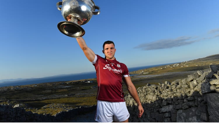Damien Comer pictured with the Sam Maguire Cup at the launch of the All-Ireland Series of the Football Championship at Dún Aonghasa on Inis Mór.