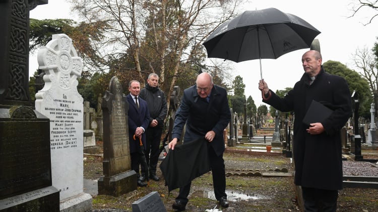 Uachtarán Chumann Lúthchleas Gael John Horan, centre, with Monsignor Eoin Thynne, right, and Dublin senior football manager Jim Gavin, left, with John Costello, Dublin GAA Chief Executive, during the unveiling of a memorial headstone to Bloody Sunday victim John William Scott who was shot and killed aged 14 at Croke Park at Glasnevin Cemetery in Dublin.