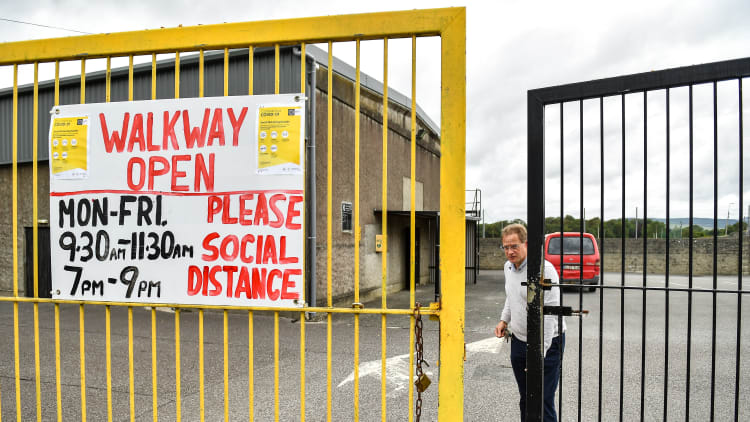 Tadhg Donavan, Chairman of Buttevant GAA Club, opens the gates to walkers at Buttevant GAA club in Buttevant, Cork.