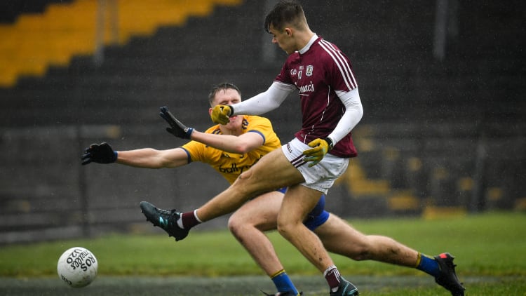 Ryan Monahan of Galway shoots to score his side's third goal, despite the attempts of Colin Walsh of Roscommon, during the EirGrid Connacht GAA Football U20 Championship Final match between Galway and Roscommon at Tuam Stadium in Tuam