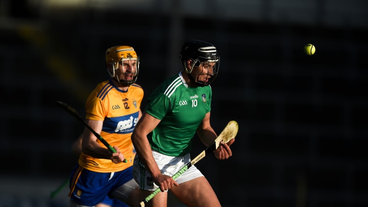 Gearoid Hegarty, Limerick, and David Fitzgerald, Clare, in Munster Senior Hurling Championship action at Semple Stadium.