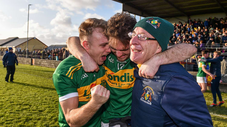 Clonmel Commercials players Kevin Fahey and Ross Peters celebrate with supporter Joe McNamara.