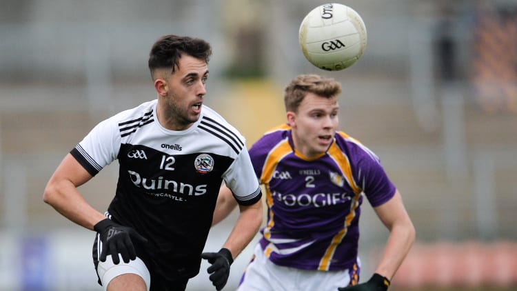 Ryan Johnston, Kilcoo, and Jack Love, Derrygonnelly Harps, during the AIB Ulster Club SFC Semi-Final at the Athletic Grounds.