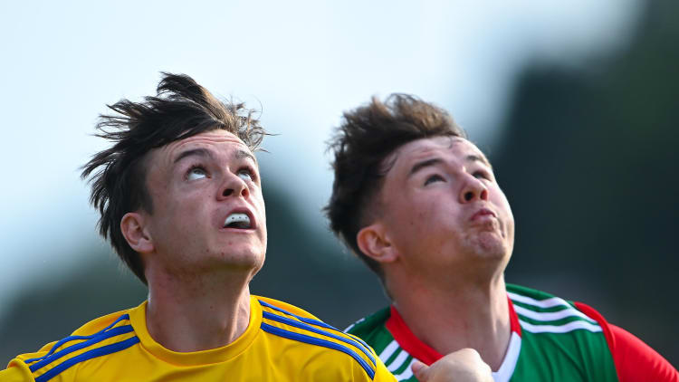 Ben O'Carroll of Roscommon and Ruairí Keane of Mayo watch the dropping ball during the EirGrid Connacht GAA Football U20 Championship Final match between Mayo and Roscommon at Elverys MacHale Park in Castlebar, Mayo.