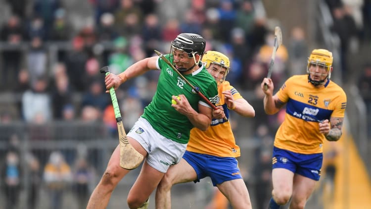 Gearoid Hegarty of Limerick s tackled by Paddy Donnellan of Clare during the 2022 Co-op Superstores Munster Hurling Cup Final match between Limerick and Clare at Cusack Park in Ennis, Clare.