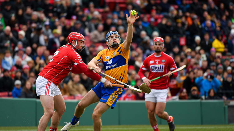 Shane O'Donnell of Clare in action against Seán O'Donoghue, left, and Colm Spillane of Cork during the Aer Lingus Fenway Hurling Classic 2018 semi-final.